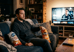 man sits on a couch in the evening