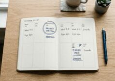 weekly planner laid flat on a light wooden desk